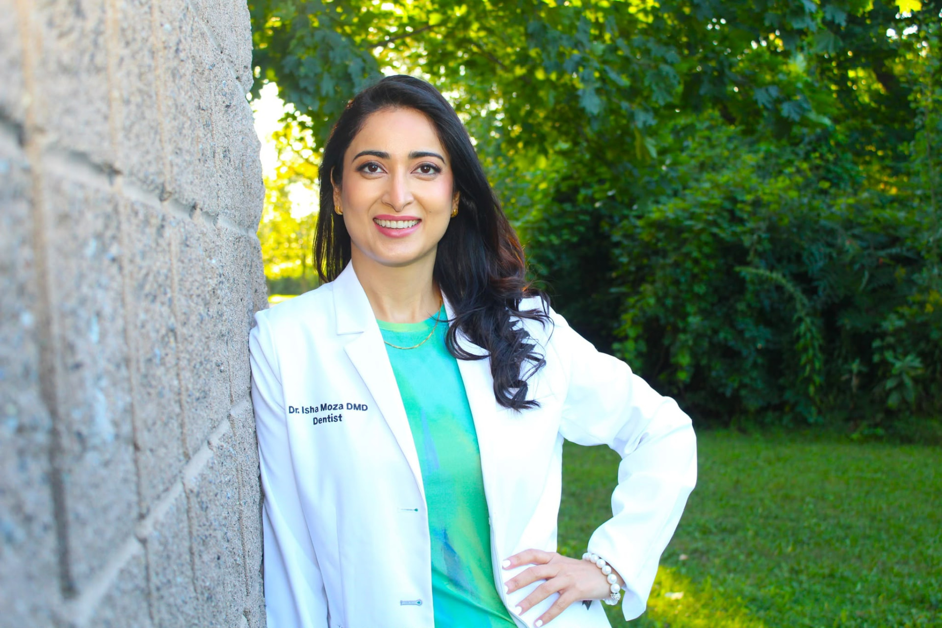 Dr. Isha Moza outdoors wearing a white coat.